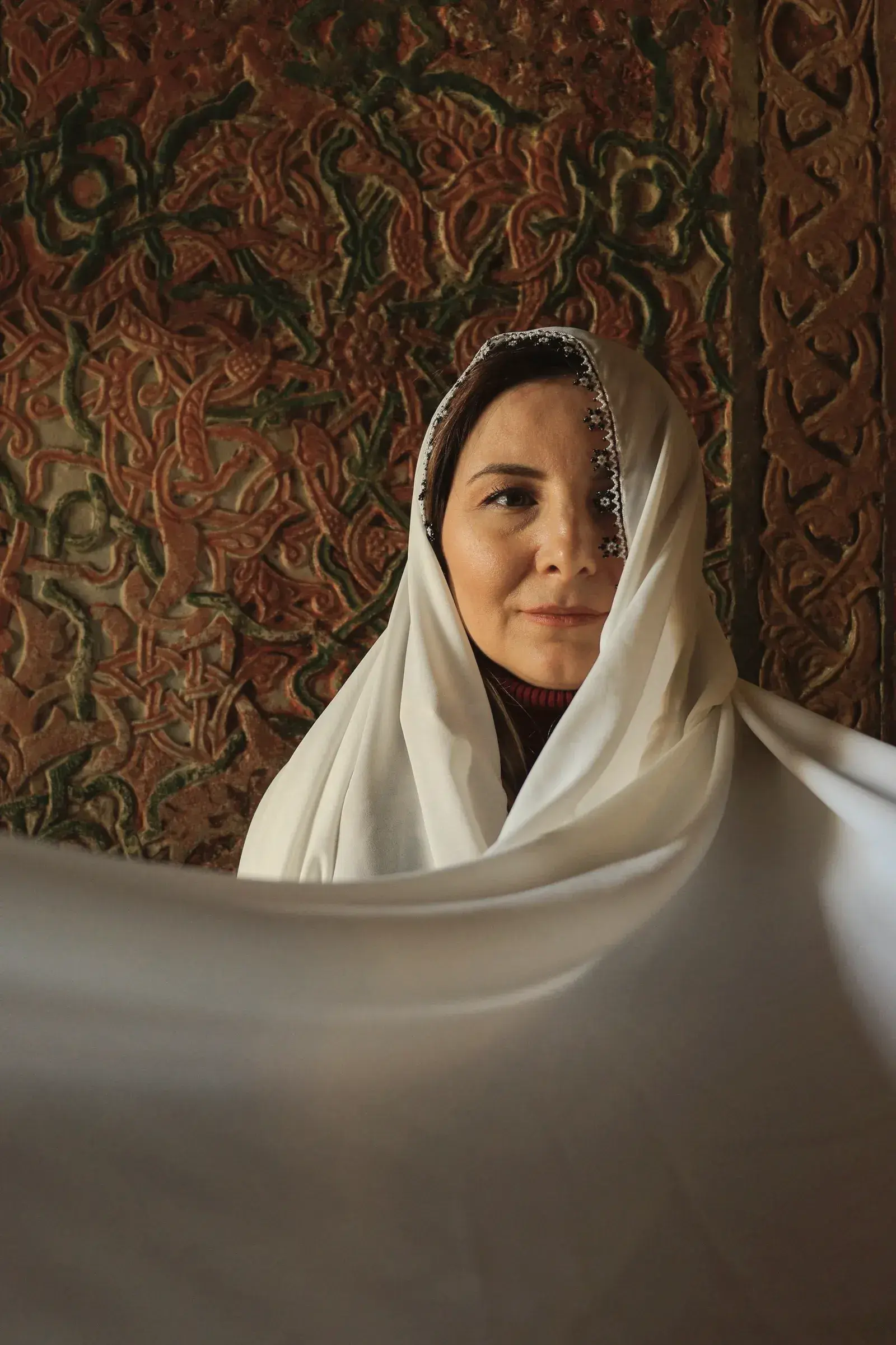 The ivory Dhakai jamdani held open across the body