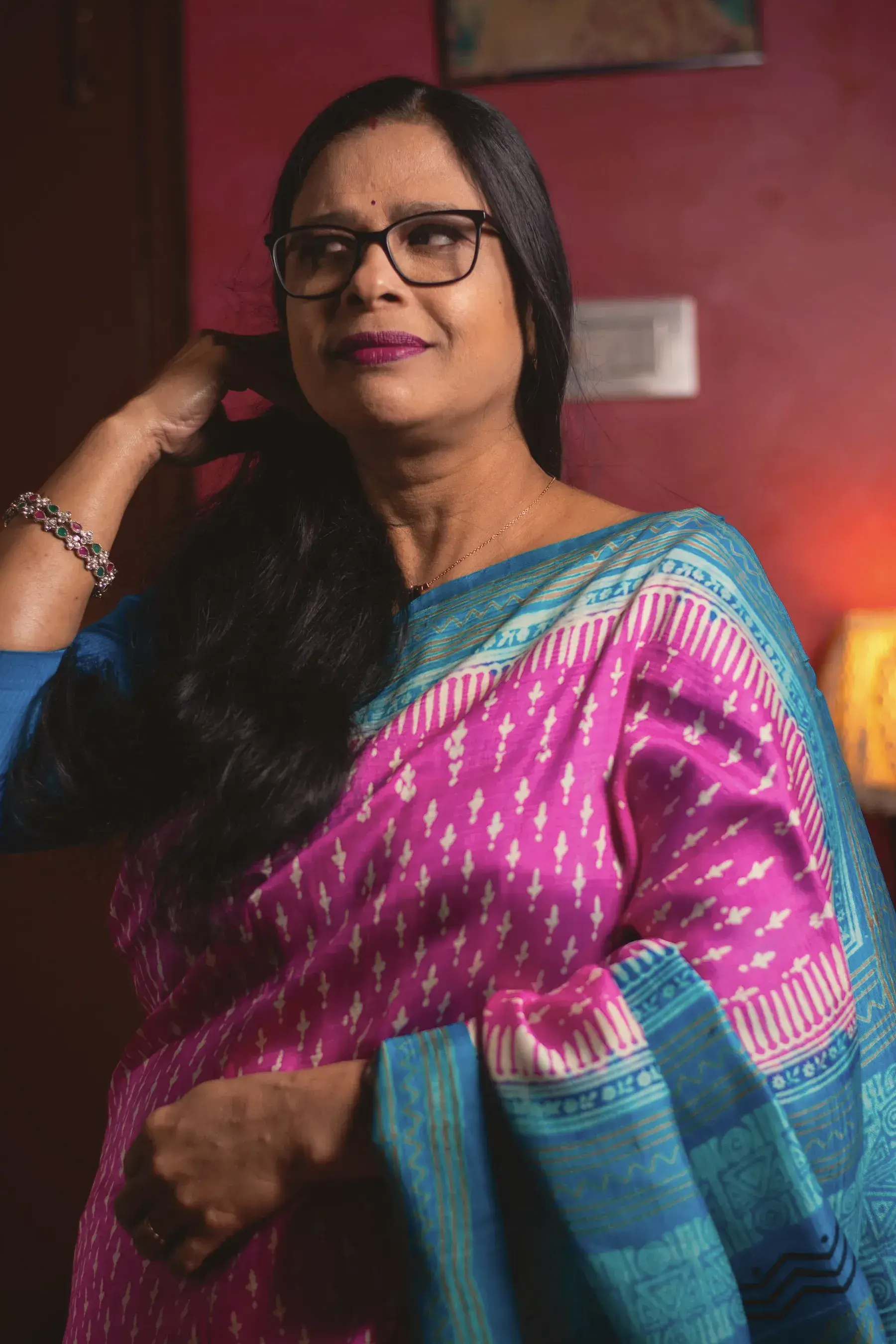 The editor in a rani pink Sambalpuri ikat silk saree with a peacock blue border